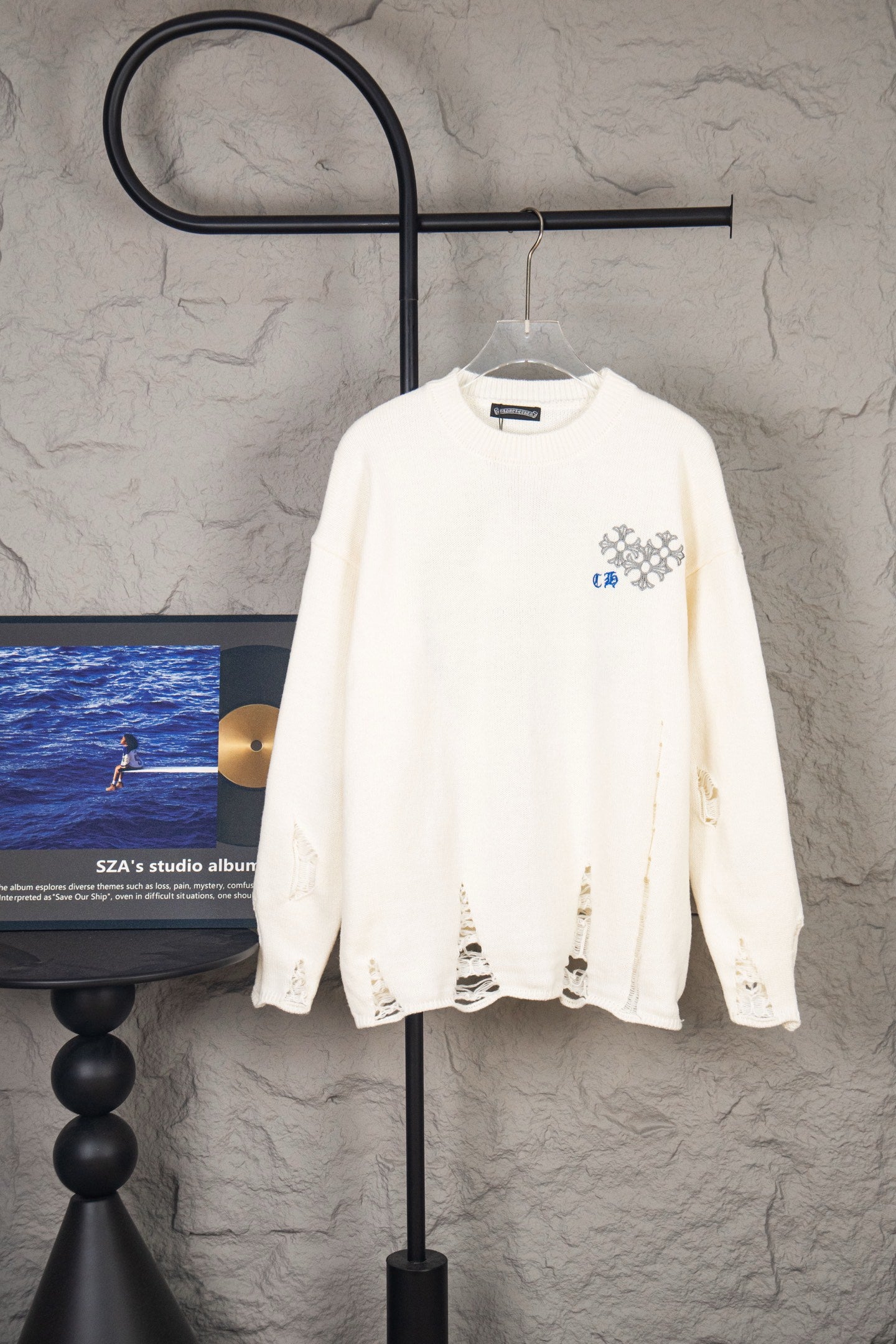 White long-sleeve knit sweater with small left chest crest logo