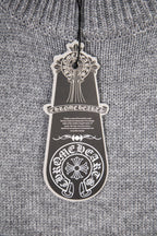 Grey knit sweater close-up with hanging white care label
