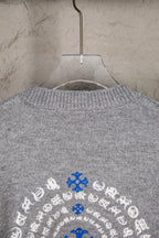 Grey knit sweater upper back with blue and white snowflake design