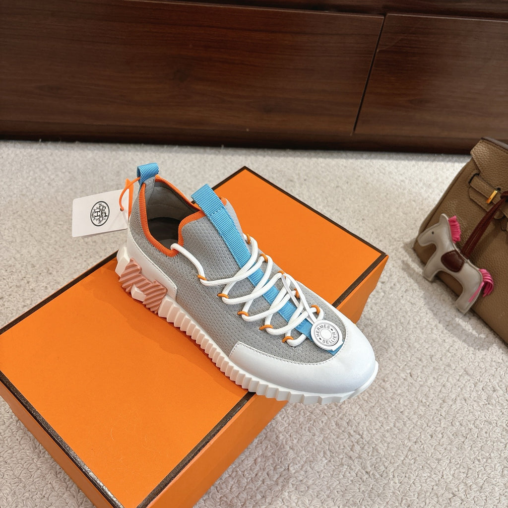 Unisex luxury sneakers with grey fabric, blue straps, white laces, and oversized white sole
