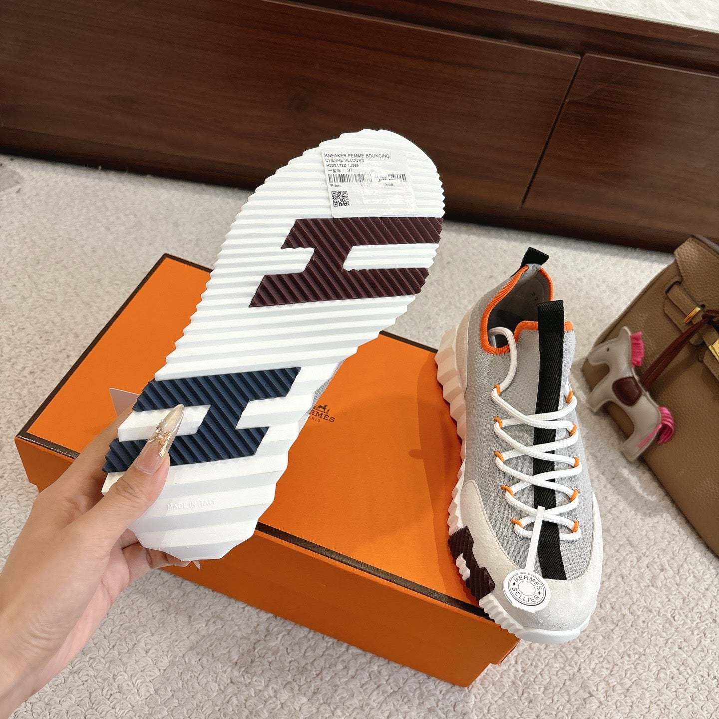 Shoe outsole detail: thick white tread with blue grips, gray upper with black panels
