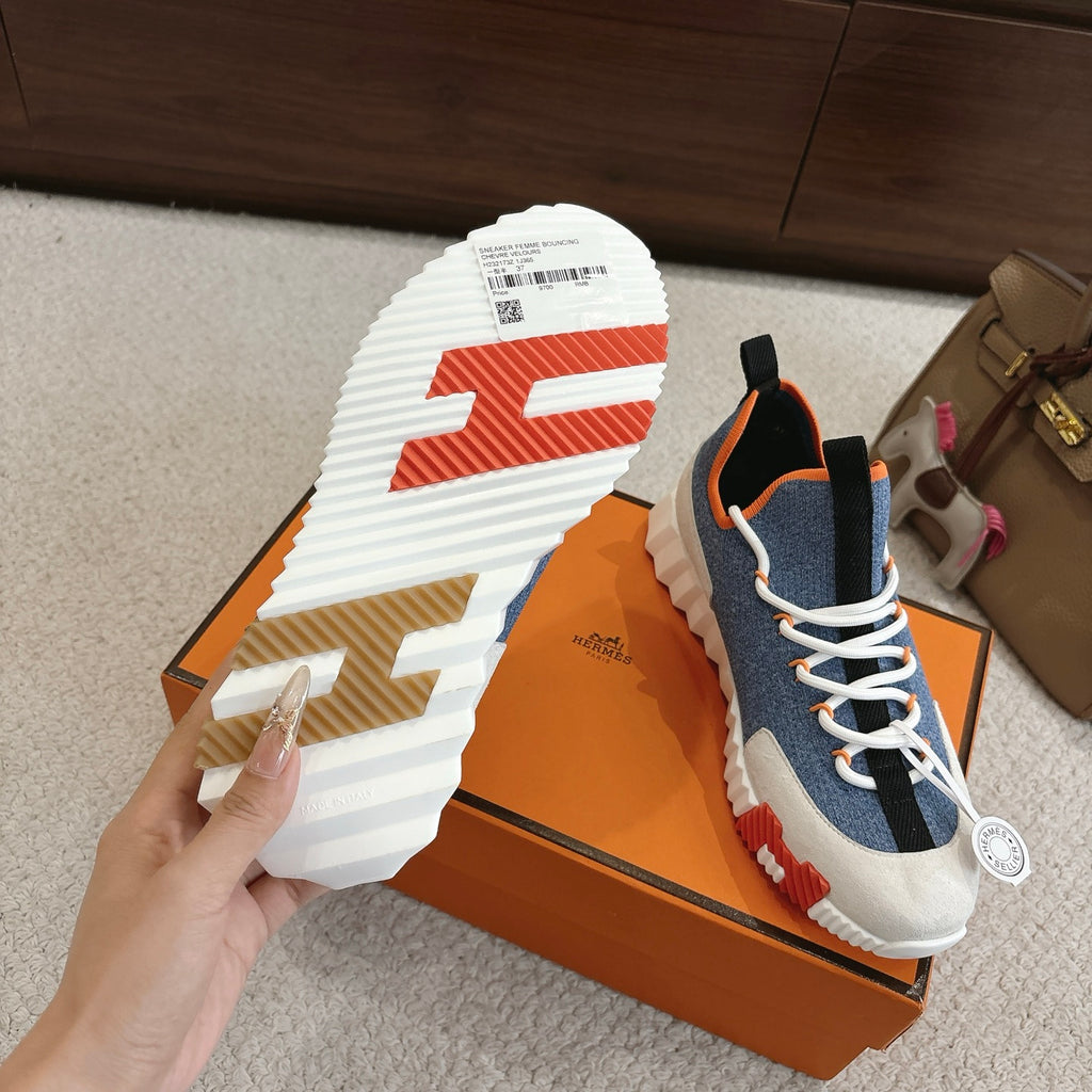 Hermes unisex sneakers outsole, white tread with orange detailing, blue upper and laces