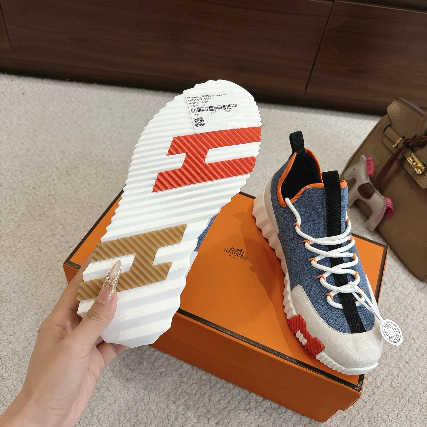 Hermes unisex sneakers outsole, white tread with orange detailing, blue upper and laces
