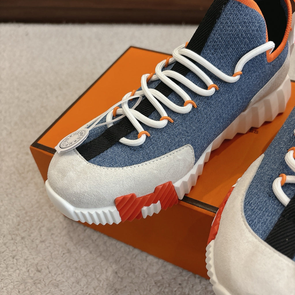Hermes unisex sneakers close-up, blue fabric and white panels, white laces and sole