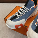 Hermes unisex sneakers close-up, blue fabric and white panels, white laces and sole