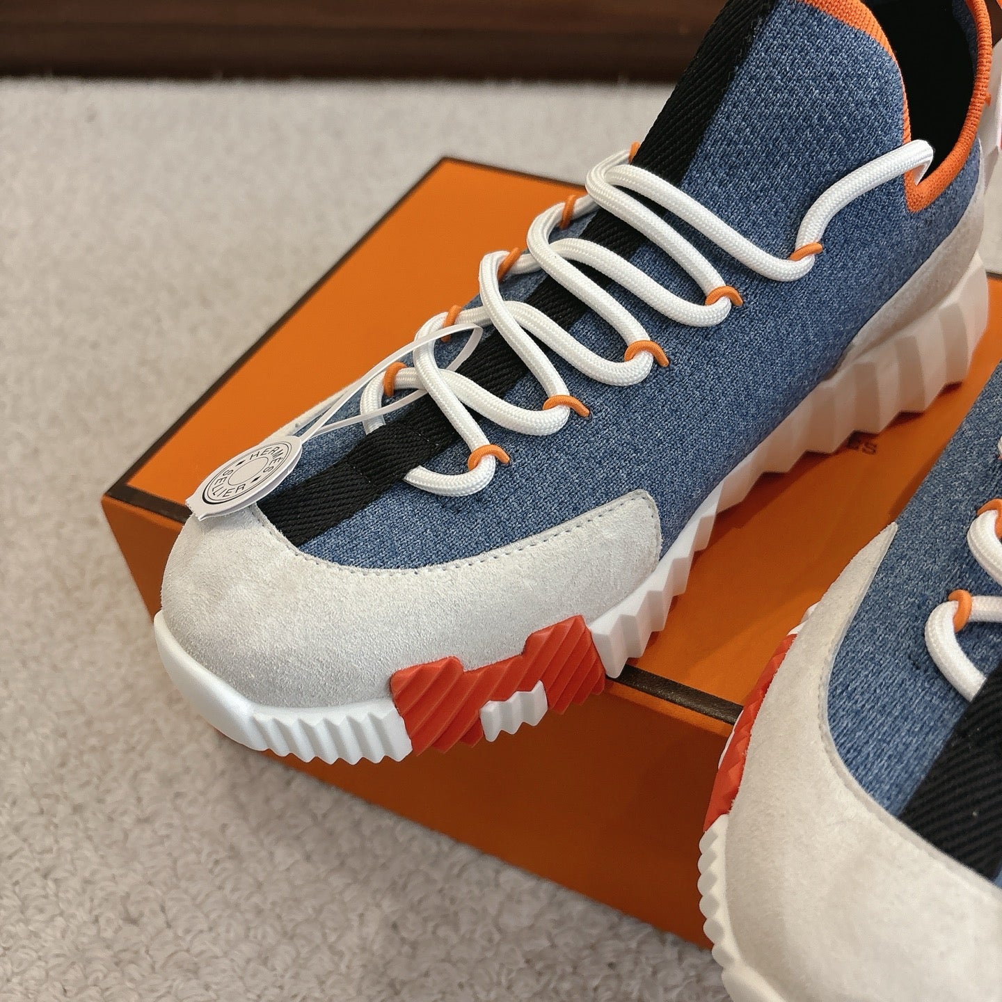 Hermes unisex sneakers close-up, blue fabric and white panels, white laces and sole