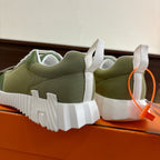 Green Hermes unisex sneaker heel view with white chunky sole and laces