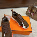 Brown mesh sneakers with dark laces and white sole, heel and side view.
