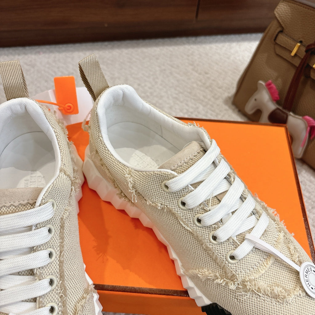 Hermes light beige sneakers with white laces and cushioned tongue detail