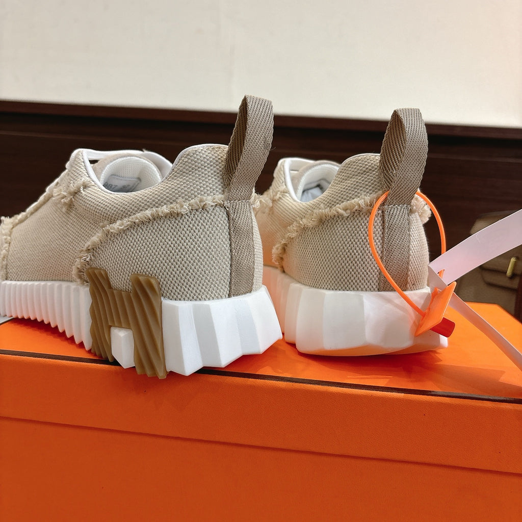 Hermes sneakers rear view in light beige with white segmented outsole tread