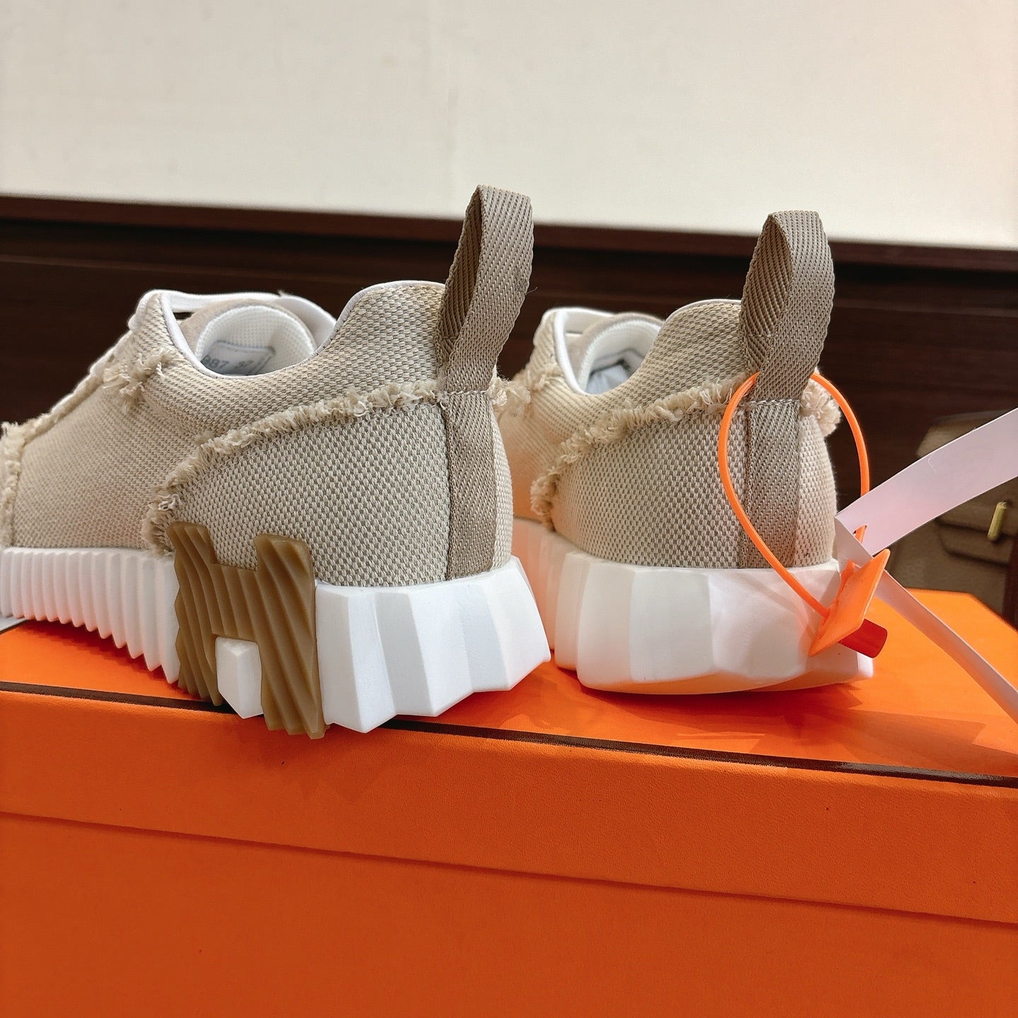 Hermes sneakers rear view in light beige with white segmented outsole tread
