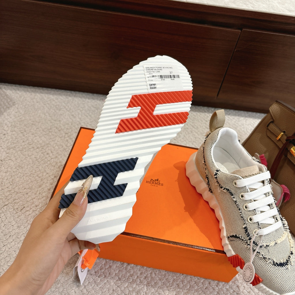Hermes sneakers outsole and side: white tread sole with navy accents; light mesh upper.