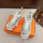 Hermes sneakers, light mesh with navy trim and white laces; thick white outsole.