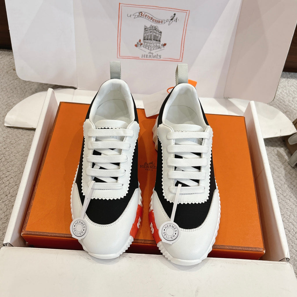 Hermes unisex sneakers, white leather with black panels and white laces.