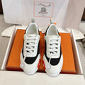 Hermes unisex sneakers, white leather with black panels and white laces.