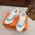 Hermes unisex luxury sneakers, white and light blue knit, lace-up design with round emblem.