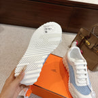 Hermes unisex luxury sneakers, outsole view with white tread and light blue upper.