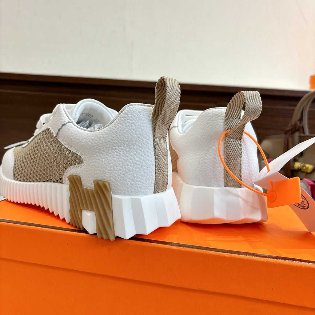 Hermes unisex sneakers heel view, white leather with tan mesh and thick textured sole.