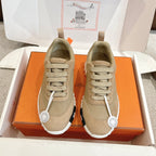 Unisex light tan suede sneakers with lace-up front and white rubber sole.