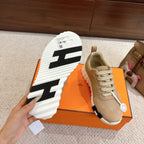 Unisex sneaker outsole view with black traction stripes on white rubber sole.