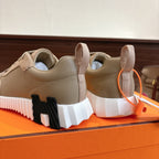 Unisex light tan sneakers heel view with black-and-white chunky sole tread.