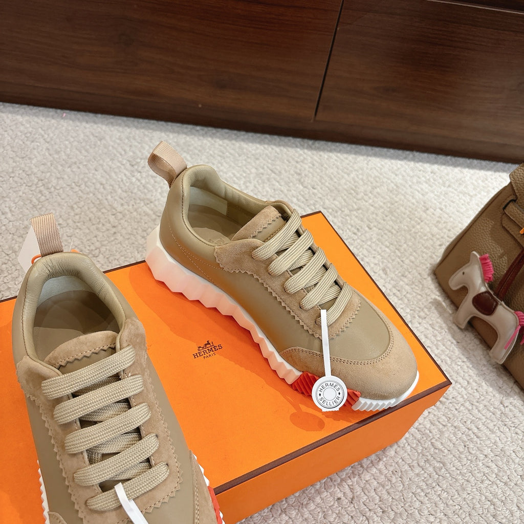 Beige suede sneakers with lace-up closure and scalloped trim along the upper edge