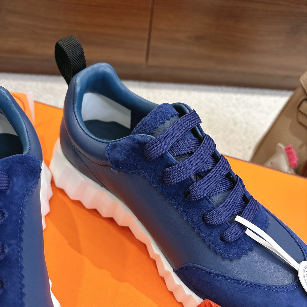 Blue unisex sneakers with navy laces, lace guard, white chunky sole detail
