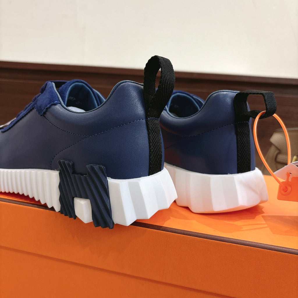 Blue unisex sneakers with black heel pull tabs and white chunky sole