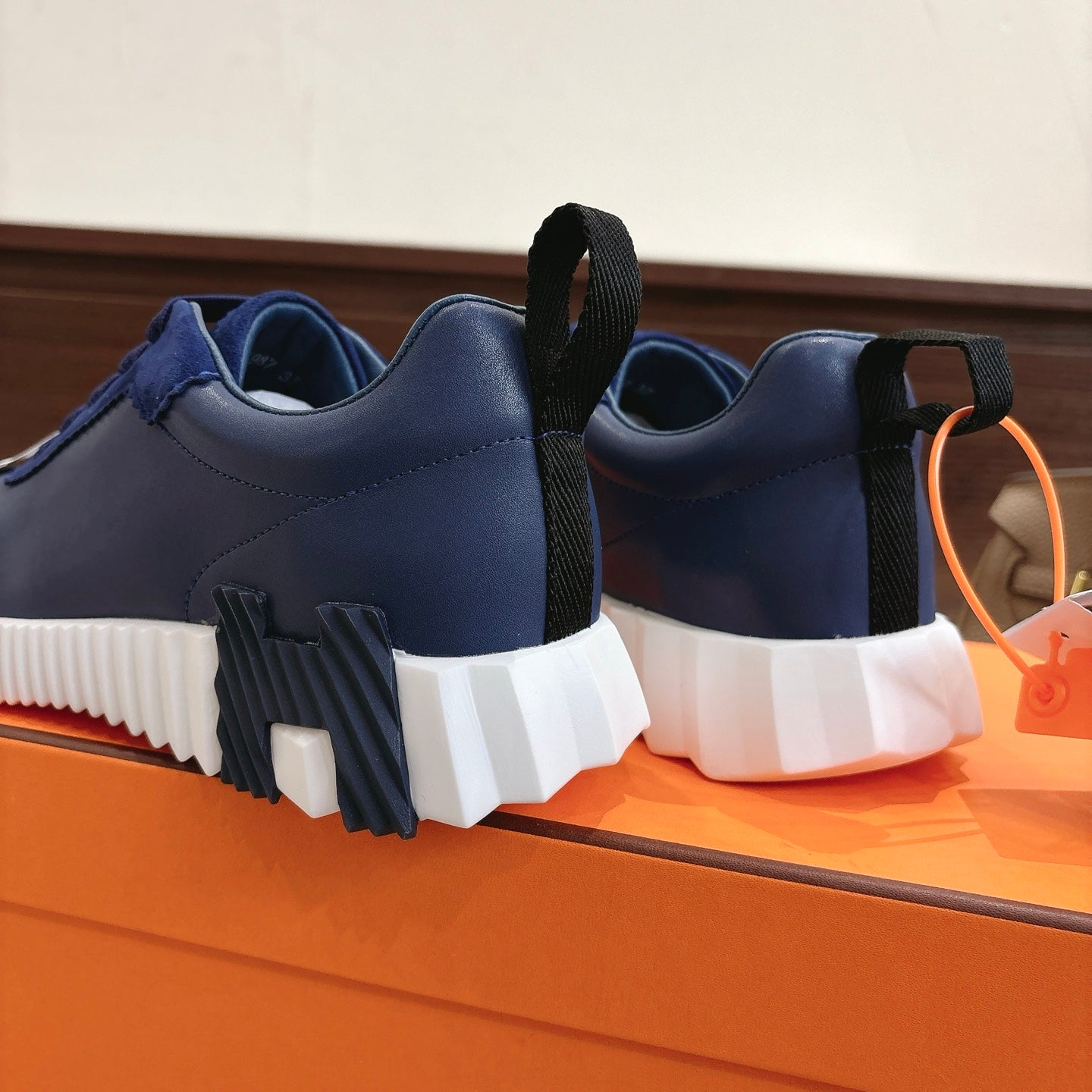 Blue unisex sneakers with black heel pull tabs and white chunky sole