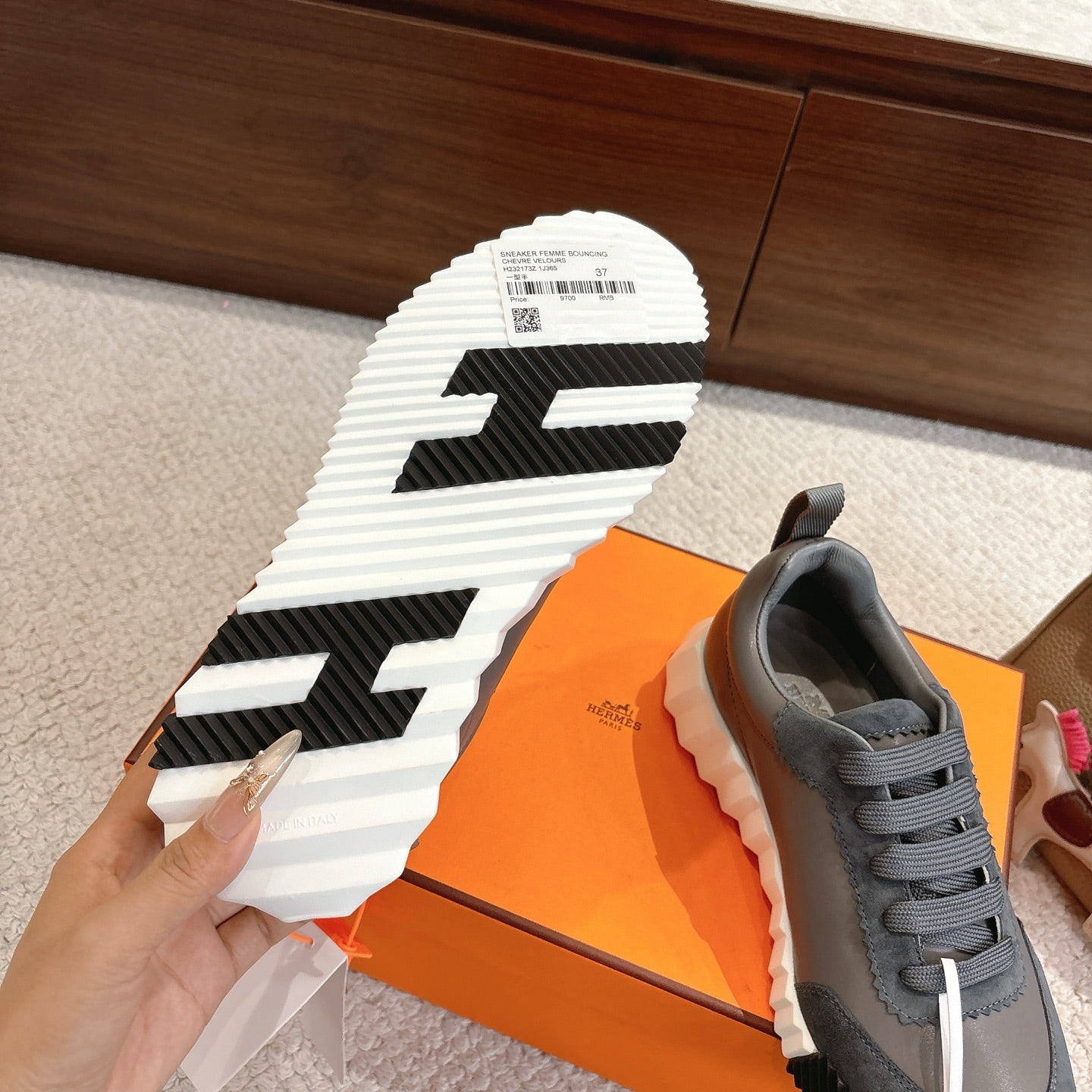 Sneaker outsole view with white tread and black chevron pattern