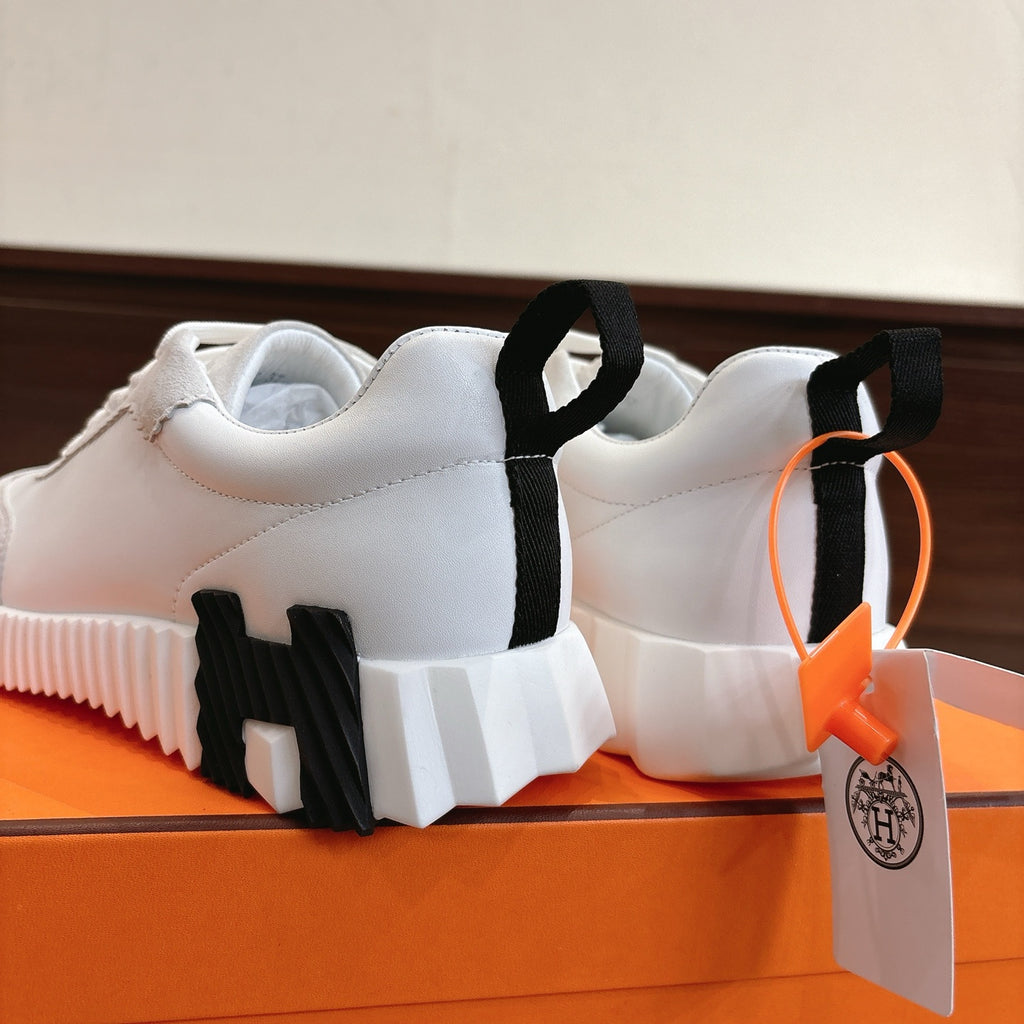 Hermes white unisex sneakers rear view, black heel tabs and chunky white midsole