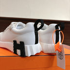 Hermes white unisex sneakers rear view, black heel tabs and chunky white midsole