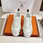 Hermes white unisex sneakers with white laces, black heel tab, chunky sole