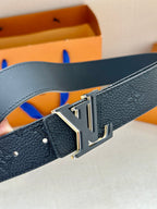 Louis Vuitton belt close-up: dark leather strap and silver-tone LV buckle