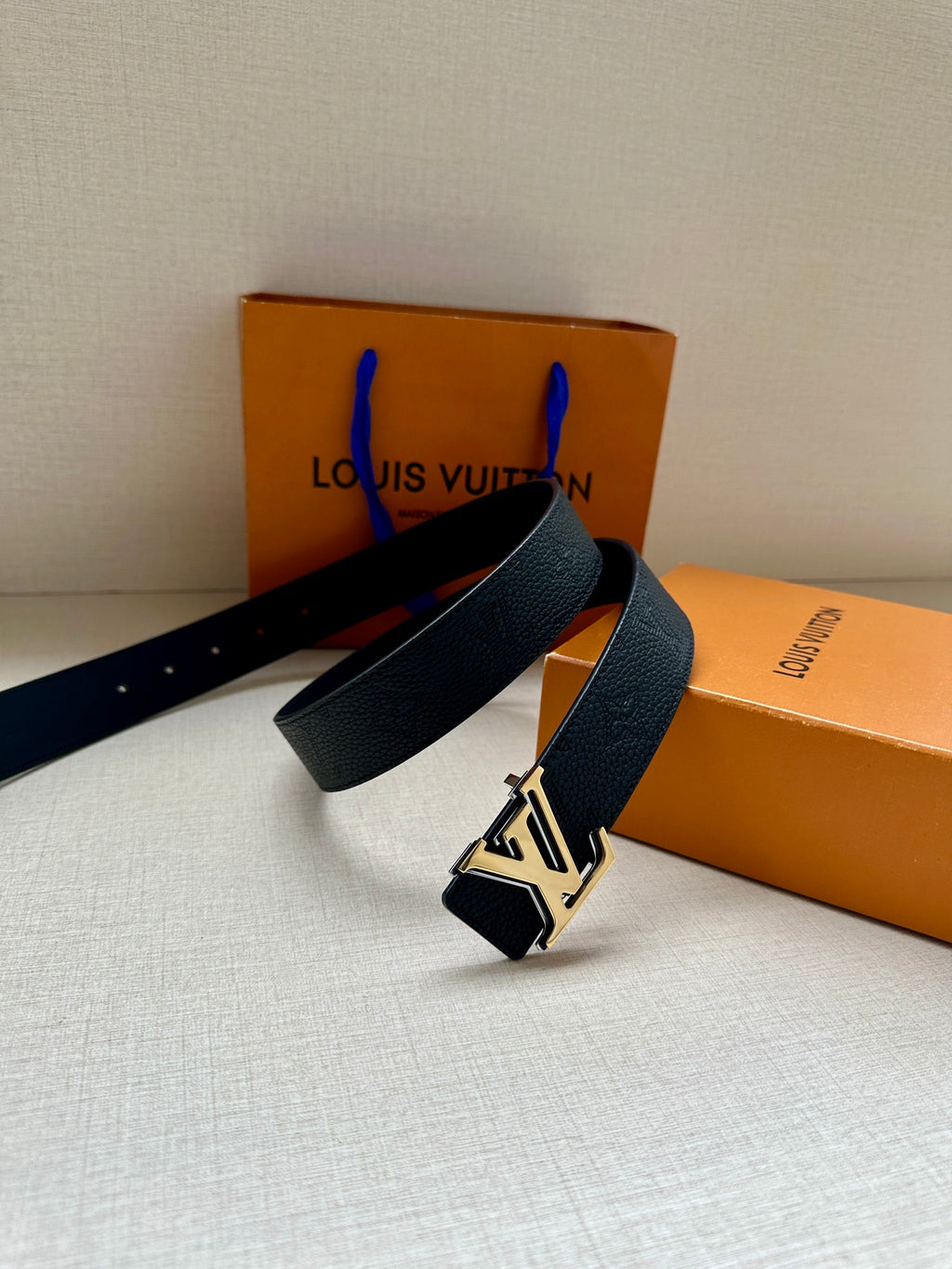 Louis Vuitton belt with silver-tone LV buckle and dark leather strap