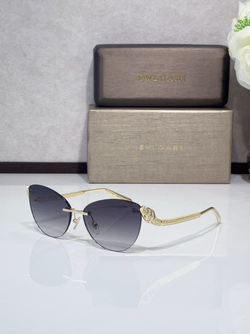 Sunglasses with gold-tone metal frames and blue-tinted gradient lenses