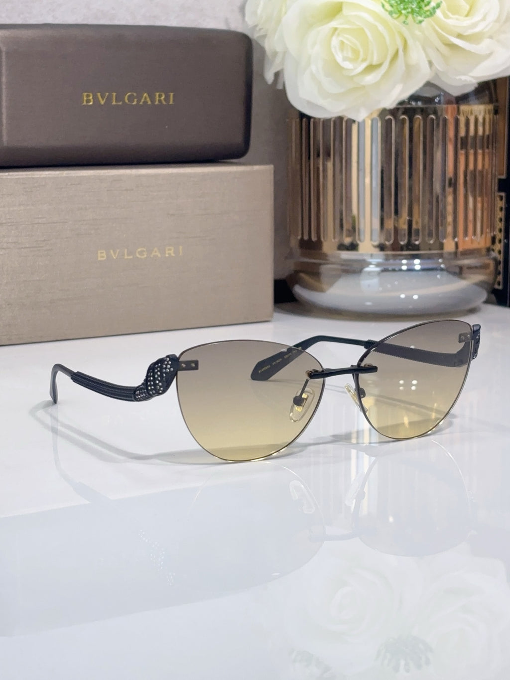 Black aviator sunglasses with tinted lenses and textured patterned arms