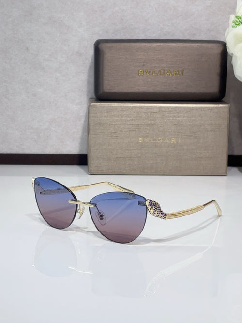 Sunglasses with gold-tone metal frames, blue-tinted gradient lenses, patterned temples