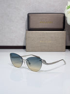 Sunglasses with metal frames, blue-tinted gradient lenses, and patterned temples