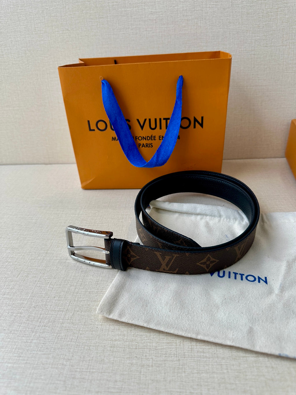 Louis Vuitton monogram belt with dark strap and silver buckle, with white dust pouch