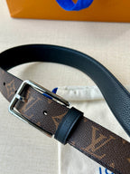 Louis Vuitton monogram belt close-up with silver rectangular buckle and dark leather strap