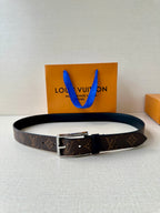 Louis Vuitton monogram belt with dark buckle and silver hardware, black leather strap