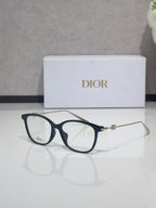 Dior glasses with dark blue acetate frames and gold metal temples, clear lenses