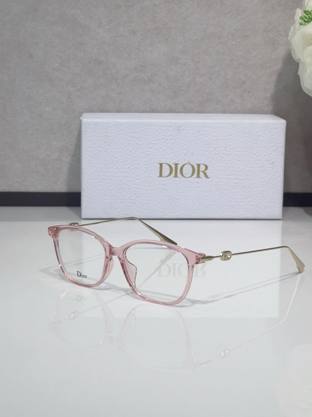 Dior glasses with rose pink acetate frames and gold metal temples, clear lenses