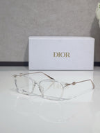 Dior glasses with clear acetate and gold accents, transparent lenses
