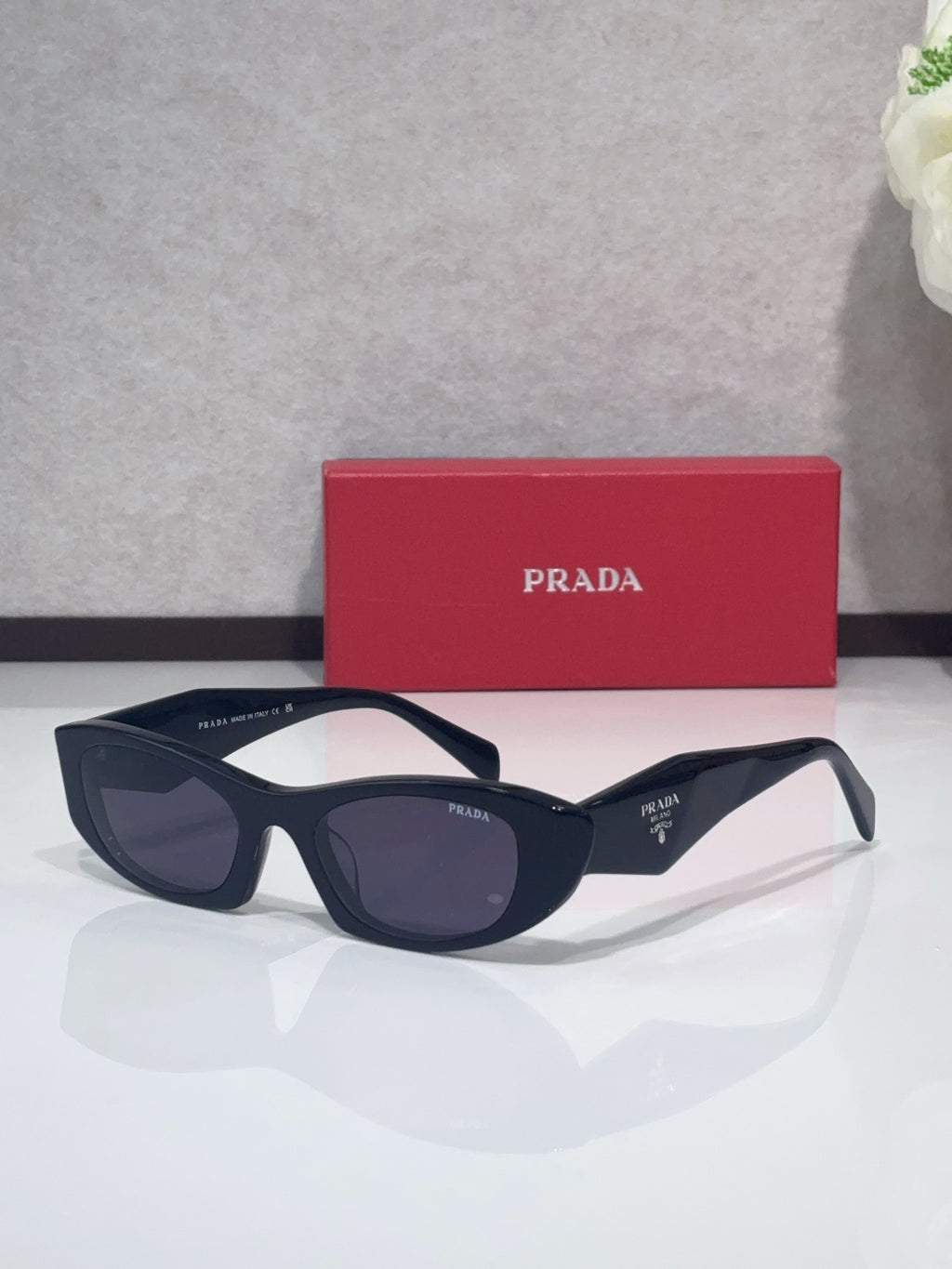 Cat-eye glasses with dark blue frames and dark lenses