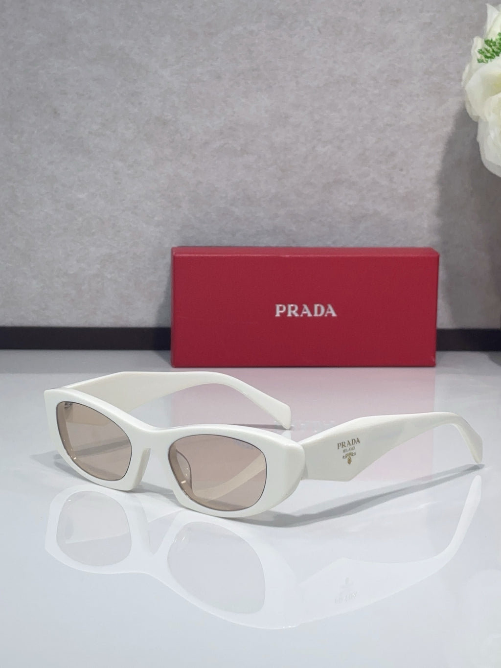Cat-eye glasses with white frames and clear lenses