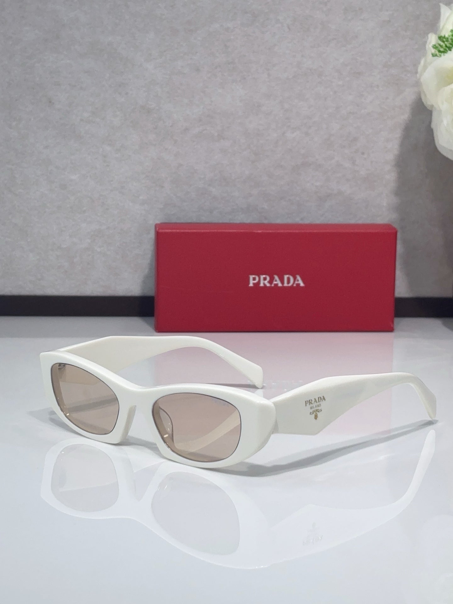 Cat-eye glasses with white frames and clear lenses
