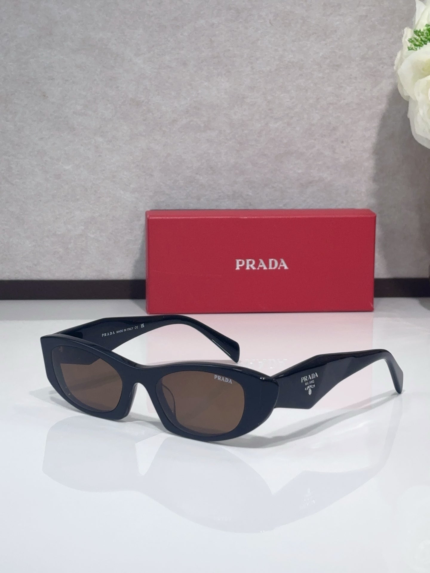 Cat-eye glasses with dark frames and brown-tinted lenses