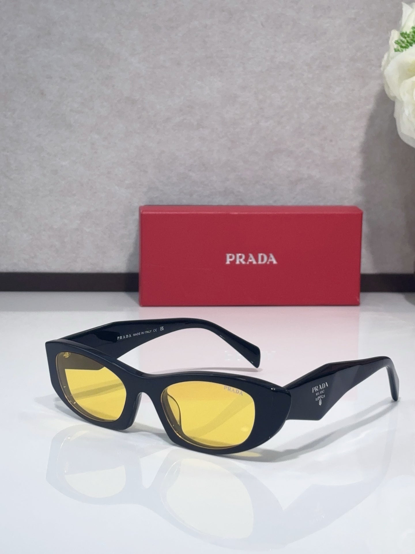 Cat-eye glasses with navy frames and yellow lenses
